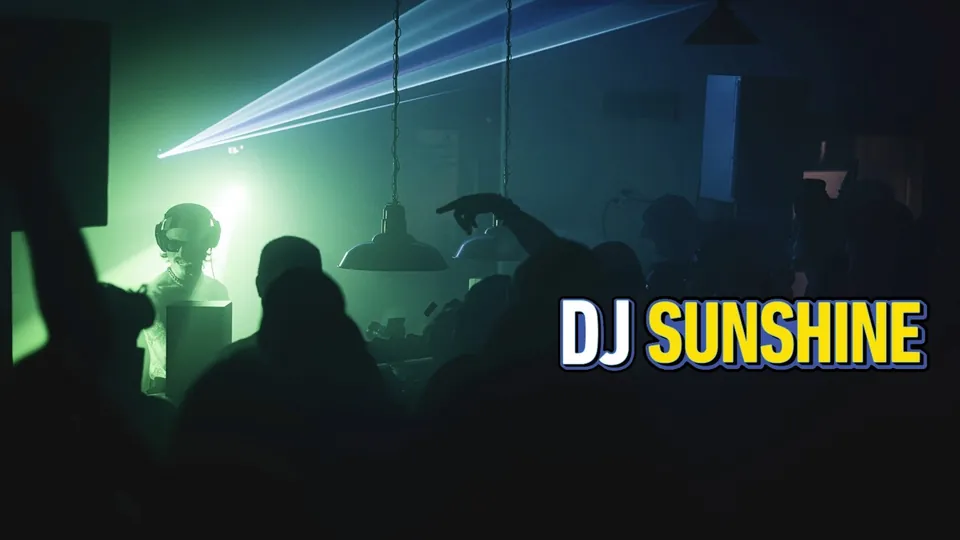 DJ Sunshine under green stage lights